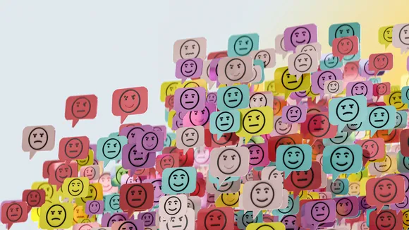 A wall full of post-its with happy, smile and angry emotions drawn