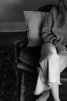 A black and white image of a woman seeking therapy in India