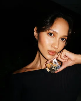 YSL Libre vanilla perfume held by model in her hand