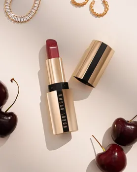 Bobbi Brown creamy matte lipstick flatlay with jewellery and cherries