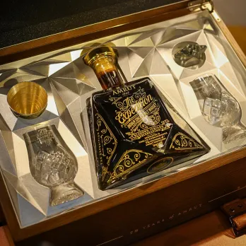 A picture of a black bottle of single malt whisky, Amrut, to depict how there is a market for Indian single malt as well s the growing popularity of single malt whisky in India.