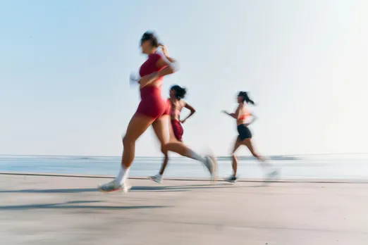 Three women running by the beach at a promenade indicating the rise of wellness in India