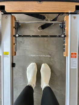 A picture of a person performing pilates on the machine