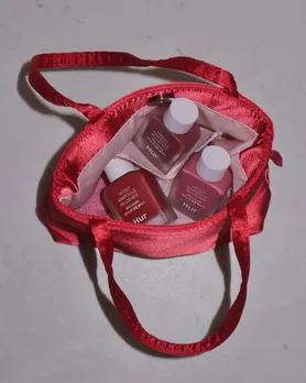 Three blushes from House of Hur, a Korean makeup brand in India, placed in a red satin bag