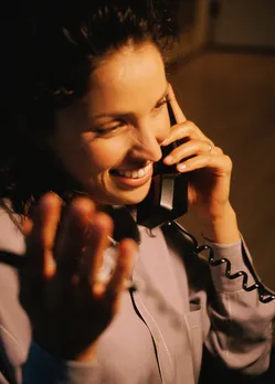 A woman talking on the phone and communicating, suggesting good markers of co-parenting