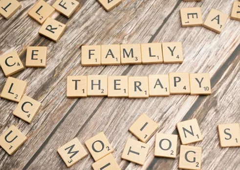 Scrabble pieces that say 'family therapy' for co-parenting