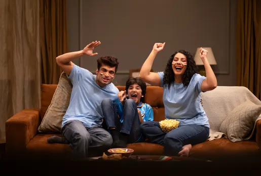 A family of three watching a cricket match