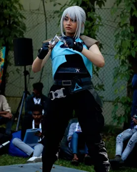 A woman dressed up in an anime outfit with blue hair, to depict Asian influence in India via cosplay and Asian culture in India like anime, besides K-dramas in India