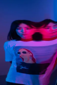 A woman wearing a t-shirt with Asian art to depict Asian influence in India, Japanese minimalism in India and East Asian beauty in India