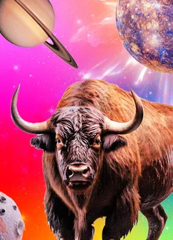 Taurus zodiac sign represented by a strong bull with Saturn and celestial bodies in the background