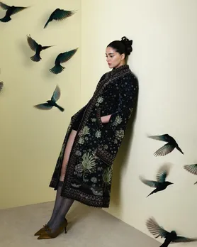 A picture of Ananya Panday, who has type-A personality, posing leaning against the wall