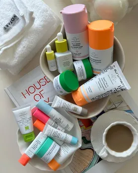 A bunch of skincare products from Drunk Elephant placed in marble trinket trays