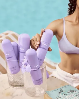 A woman by the pool picking d'you milky toner from cocktail glasses