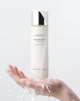 A bottle of TirTir milky toner on a woman's hand
