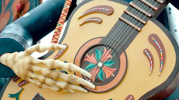 The Musician embodies joy, rhythm and the idea that love continues to resonate beyond time through music.