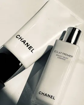 A bottle of Chanel's milky toner placed next to a primer tube from the brand