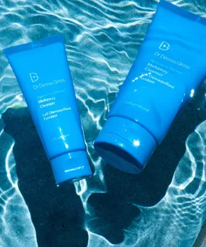Two blue milky non foaming cleansers from Dr Dennis Gross placed in water