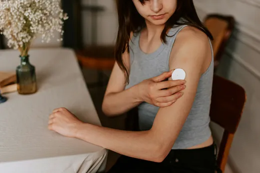 A woman monitoring her health via a device