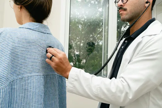 A male doctor checking a female patient with autoimmune diseases in women at the clinic