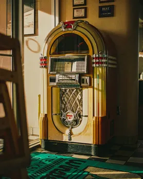 A vinyl record player, jukebox style, to show how vinyl records in India are becoming more accessible to the crowd via vinyl bars India, inspired by Japanese vinyl bars