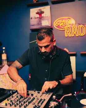 A man DJs with an analog vinyl system to show how vinyl records in India are gaining popularity via vinyl bars India like Gaijin in Mumbai
