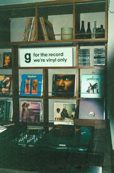 A record player at Genre with a sign that claims they play vinyls only to show the increasing popularity of vinyl records in India, vinyl culture India and vinyl listening rooms India via vinyl bars India like Genre