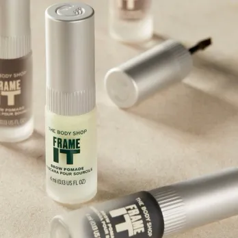 Two eyebrow gels from The Body Shop placed on a marble surface