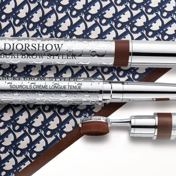 Eyebrow pencil with brush from Dior Beauty placed on a surface with Dior's logo
