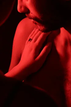 A picture of a woman's hand on a man's body to show how ChatGPT erotica in India and consent and AI could have an impact of real life safety