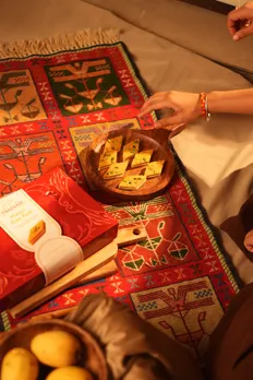 A picture of a box of Kaju Katli in India with a plate of the premium Indian mithai showing the offerings of 7 Bazaari which works well for Indian gifting sweets