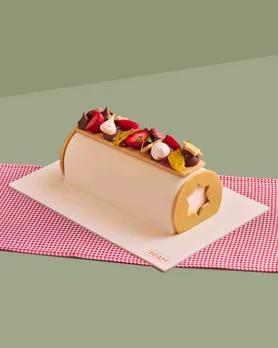 A slice of the Miam Patisserie's version of the Yule log cake India which is viewed as one of the Best Christmas Cake in India and makes for Christmas food gifts India