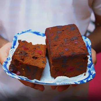 A plate with a loaf and a slice of cake at Confeitaria 31 de Janeiro, touted to be one of best plum cake India and hence, the best Christmas Cake in India