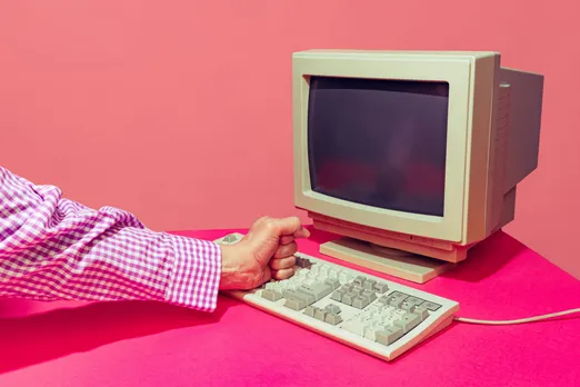 A man using the keyboard and desktop, reflecting the digital divide in India