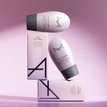 Two bottles of the House of Makeup skin tint placed on their outer cartons against a lavender backdrop
