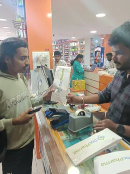 Pharmacist giving DocPharma bag to a delivery boy