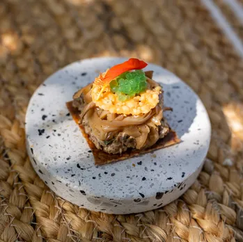 WALNUT TOSTADA – Tempered Corn Cream, Pickled Oysters, Nasturtium