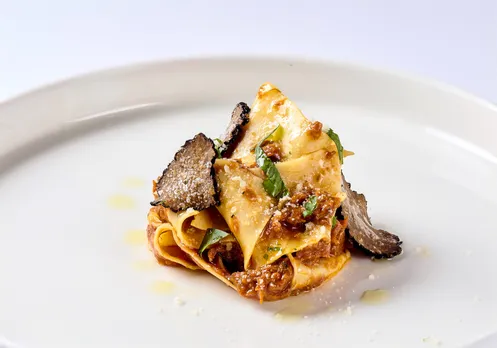 Homemade pappardelle pasta tossed with slow cooked roasted duck ragout, parmiggiano reggiano and a drizzle of truffle oil