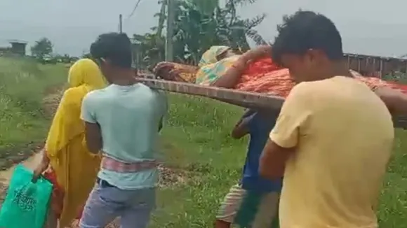 Murshidabad Suti pregnant woman stretcher carried to hospital bad road,Suti Murshidabad road condition pregnant woman hospital villagers,Murshidabad Suti village women carried on cot due to no motorable road,Suti I block dilapidated road pregnant patient carried by villagers,Murshidabad health emergency road access poor condition,মুর্শিদাবাদ সুতিতে সড়কের দুরবস্থা গর্ভবতী মহিলা খাটিয়ায় চাপিয়ে হাসপাতালে,সুতি অঞ্চলে গ্রামবাসীরা গর্ভবতী মহিলাকে ঢেকুড়ি নিয়ে হাসপাতাল নিয়ে গেছে,সুতি‑১ ব্লকে খারাপ রাস্তা গর্ভবতী মহিলাকে ভাসমান খাটিয়ায় হাসপাতালে,মুর্শিদাবাদ সুতির সড়কের অবস্থা গর্ভবতী রোগী খাটিয়ায়,সুতি এলাকায় রাস্তা না থাকায় মহিলাকে খাটিয়ায় হাসপাতাল নেওয়া