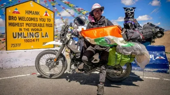 Man,world's highest motorable road,pet dog,ladakh,Umling la,Instagram,bike