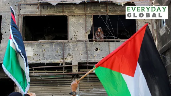 A woman looks on as Syrians gather during a pro-Palestinian protest to express solidarity with Palestinians in Gaza, in Yarmouk Palestinian refugee camp, near Damascus, Syria, October 20, 2023