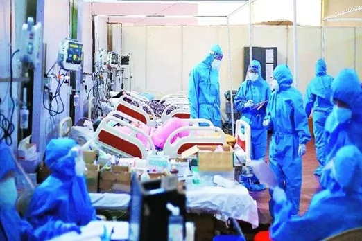 Nurses and health workers attend critical covid positive patients inside an ICU facility run by Navi Mumbai Municipal Corporation during the second wave of the pandemic. (Express Photo by Amit Chakravarty)