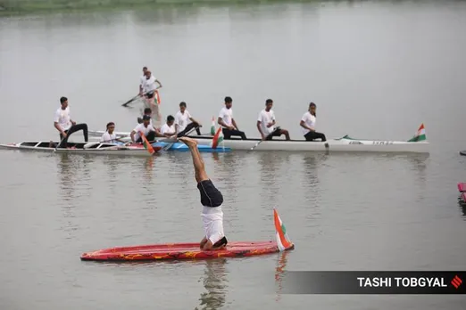 People perform yoga exercises on the banks and in the Yamuna river on the occasion of International Yoga day in New Delhi on Wednesday. (Express photo by Tashi Tobgyal)