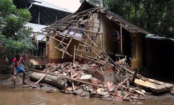 A man removes debris from a collapsed house after floods in Paravur in Kerala Reuters photo