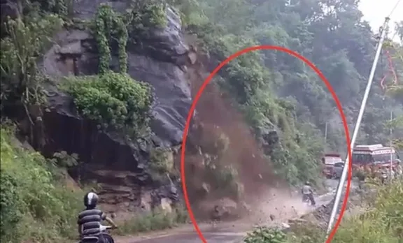 കൂറ്റന്‍ പാറകളും മണ്ണും ഇടിഞ്ഞുവീണു; സ്കൂട്ടര്‍ യാത്രക്കാരന്‍ രക്ഷപ്പെട്ടത് തലനാരിഴയ്ക്ക്