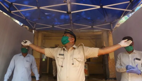 Mumbai police are seen inside a full-body sanitizing machine outside Dharavi police station in 90 feet road, Dharavi. Express photo by Prashant Nadkar, Sunday, 12th April 2020, Mumbai, Maharashtra.