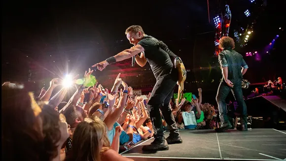 Bruce Springsteen Signs School Absentee Note For Young Fan at Concert