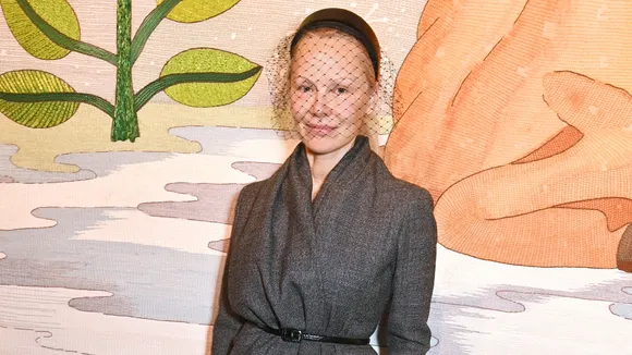 Pamela Anderson Shines Barefaced in Retro Veiled Headband at Dior Paris Fashion Week