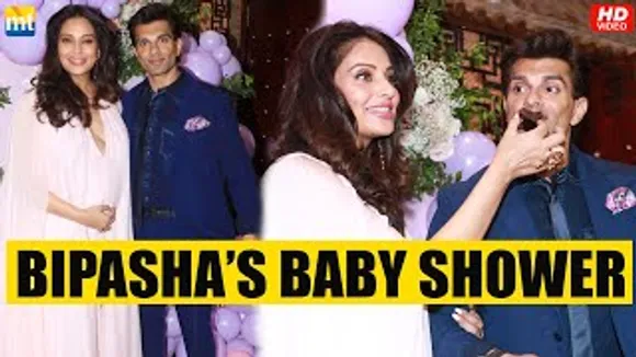 Bipasha Basu exudes pregnancy glow as she feeds Karan Singh Grover a cake at her baby shower