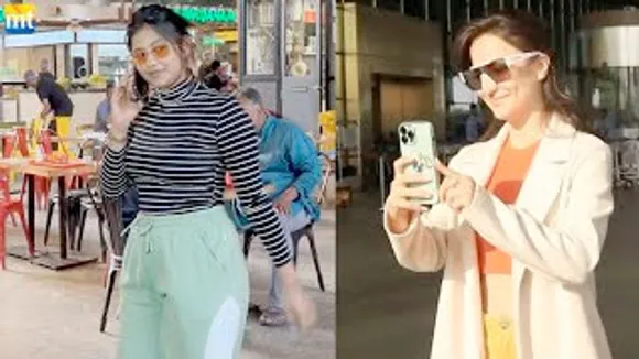 Elli AvrRam TURNS Cameraman in Long Coat; Kacha Badam Anjali Arora in Black & Green Combo at airport