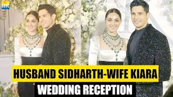 Bride Kiara Advani In Gown Groom Sidharth Malhotra in sparkly blazer at their Wedding Reception